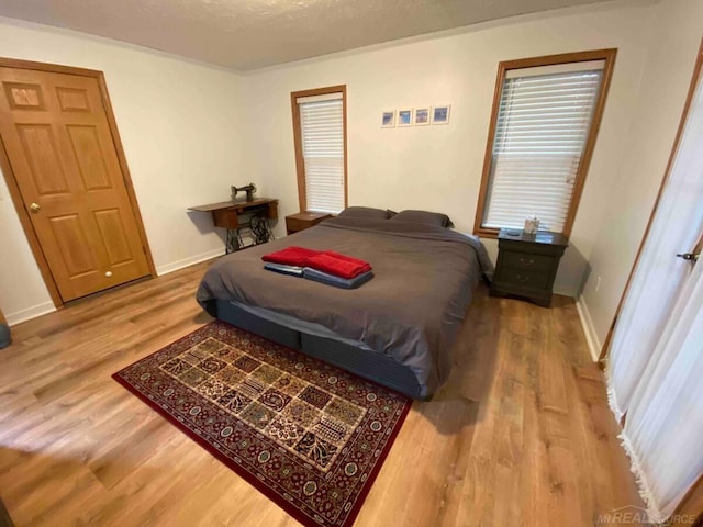 bedroom with hardwood / wood-style flooring and a textured ceiling