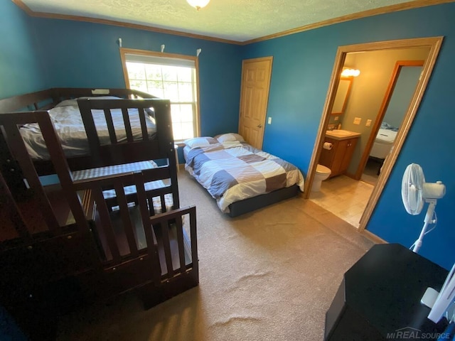 carpeted bedroom with ornamental molding, connected bathroom, and a textured ceiling