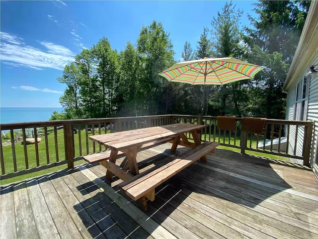 deck featuring a water view and a yard