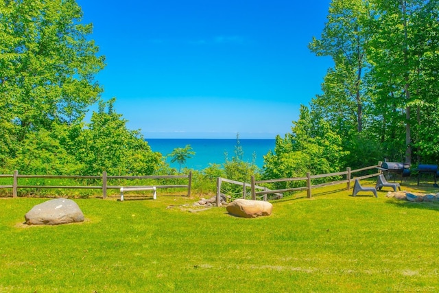 exterior space featuring a water view and a lawn