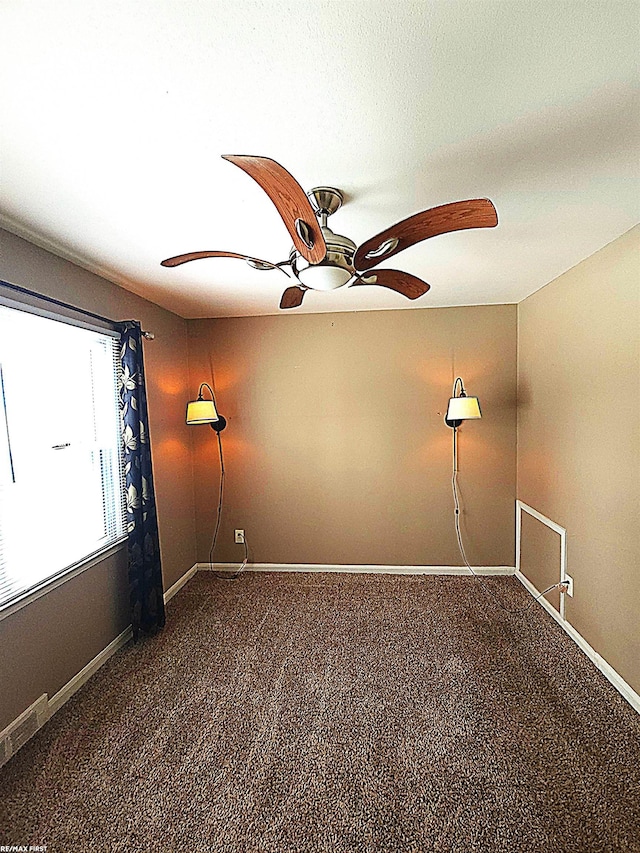 carpeted spare room with ceiling fan