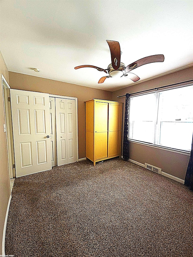 unfurnished bedroom with carpet flooring and ceiling fan