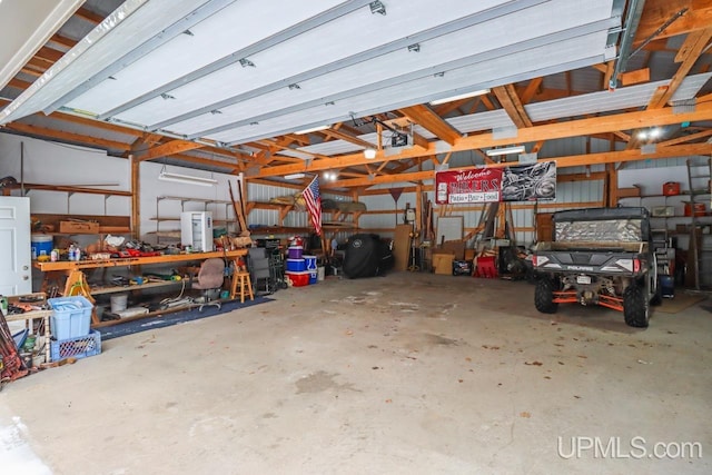 garage with a garage door opener and a workshop area