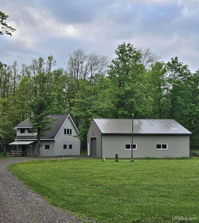 view of outbuilding featuring a garage and a yard