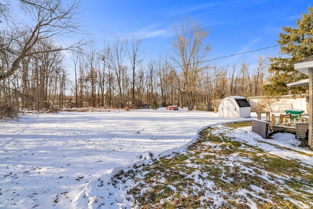 snowy yard with a shed