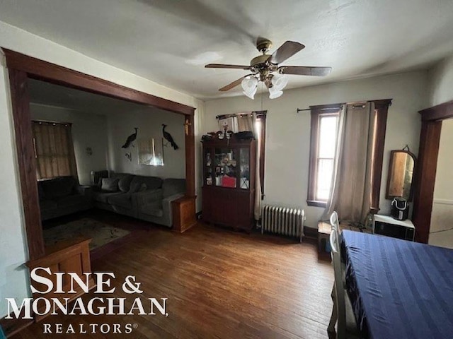 unfurnished bedroom with radiator, dark wood-type flooring, and ceiling fan