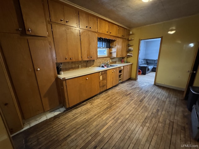 kitchen with sink and light hardwood / wood-style flooring