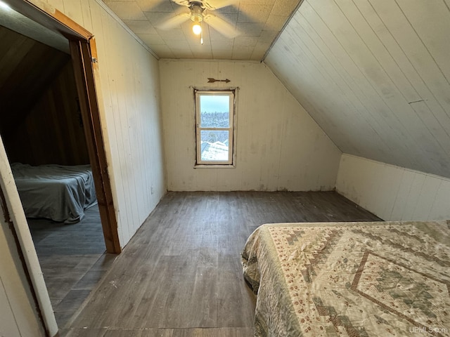 unfurnished bedroom with dark hardwood / wood-style flooring, lofted ceiling, and ceiling fan