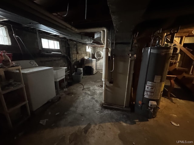 basement with water heater, washer / dryer, sink, and heating unit