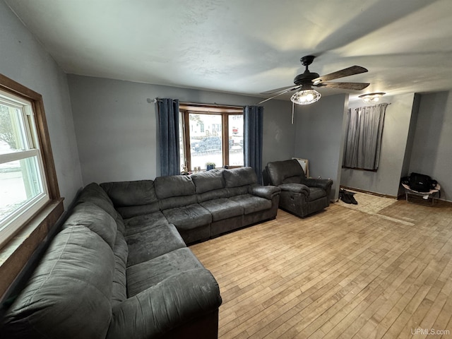 living room featuring ceiling fan and light hardwood / wood-style flooring