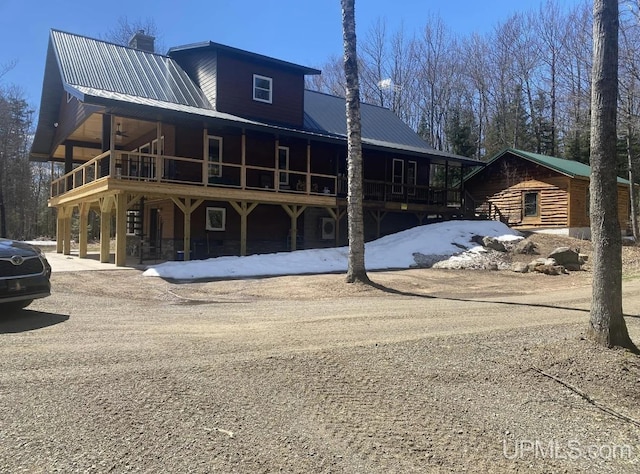 view of front of house featuring an outbuilding and a deck