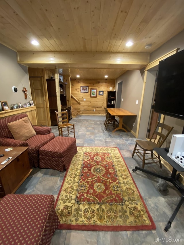 living room with beamed ceiling, wooden ceiling, and wood walls