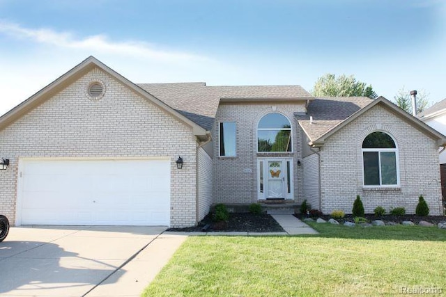 view of front of property featuring a garage and a front yard