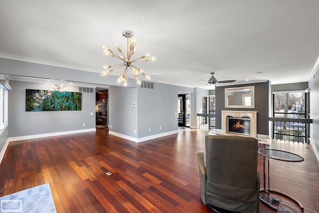 living room with crown molding, dark wood-type flooring, and a premium fireplace