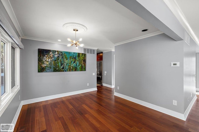 unfurnished room featuring ornamental molding, dark hardwood / wood-style flooring, and a chandelier