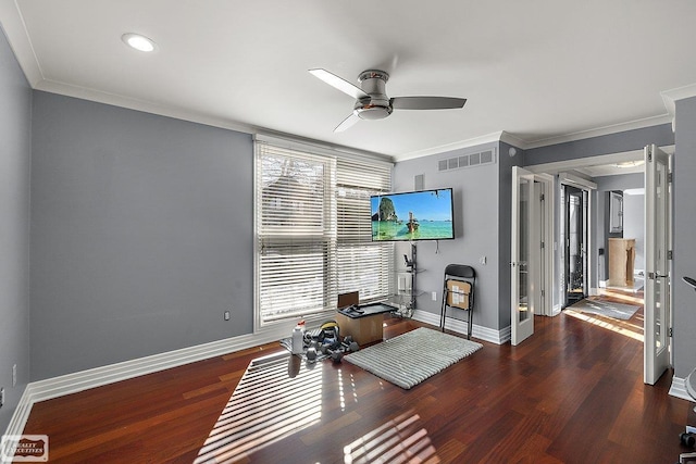 workout area with dark wood-type flooring, ceiling fan, and crown molding