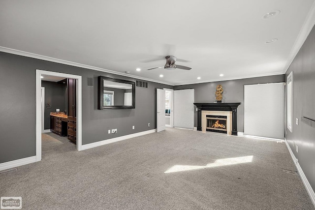 unfurnished living room with crown molding, light colored carpet, and ceiling fan