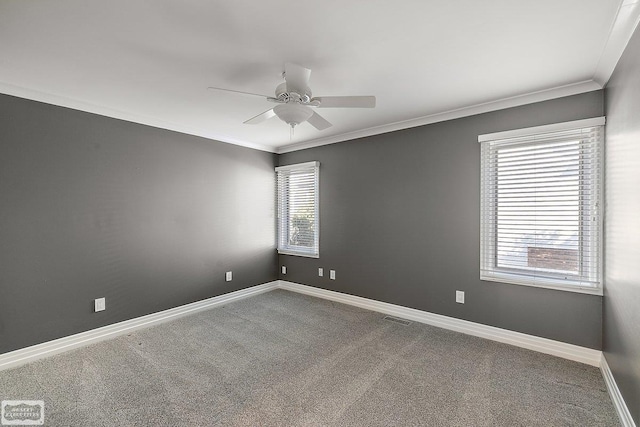 empty room featuring ornamental molding, carpet floors, and ceiling fan