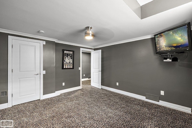 unfurnished bedroom with ceiling fan, ornamental molding, and carpet floors