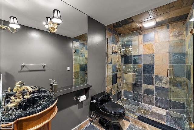 bathroom featuring a shower with door, vanity, and toilet