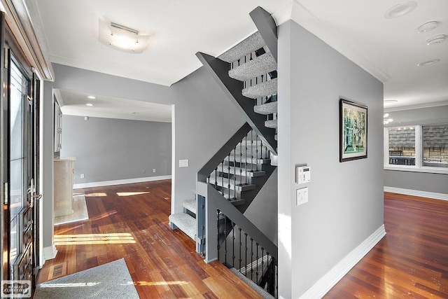 stairway featuring crown molding and wood-type flooring