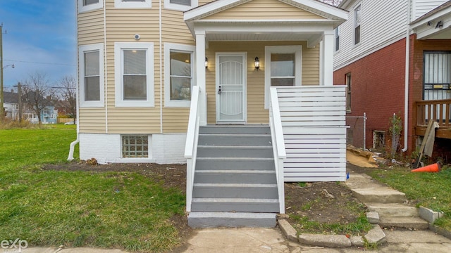 entrance to property with a lawn