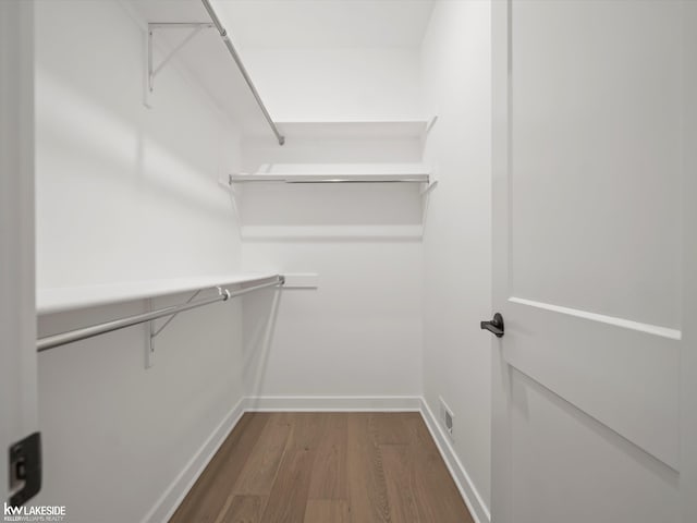 spacious closet featuring hardwood / wood-style flooring