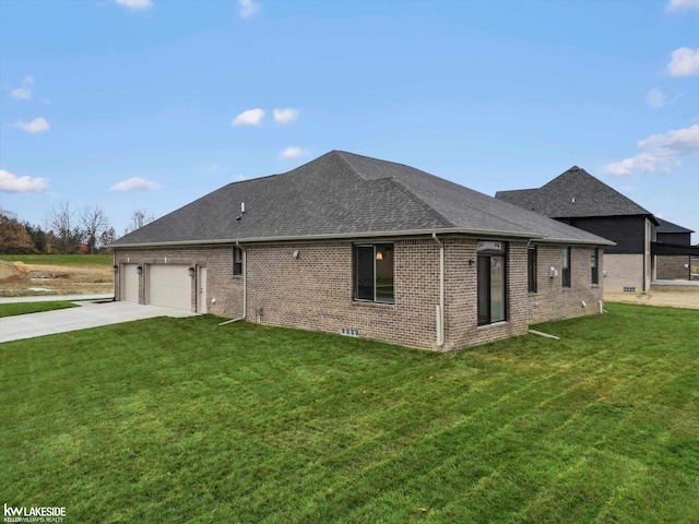 rear view of property with a yard and a garage