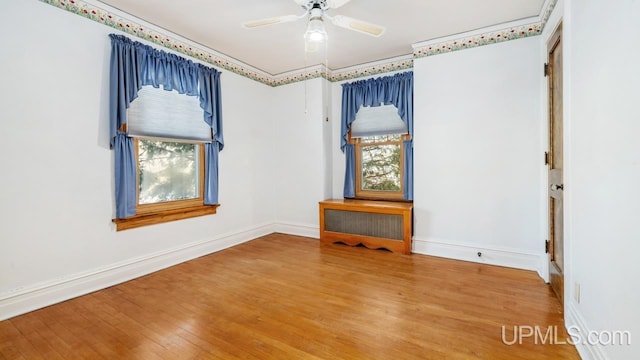 empty room with hardwood / wood-style flooring and ceiling fan