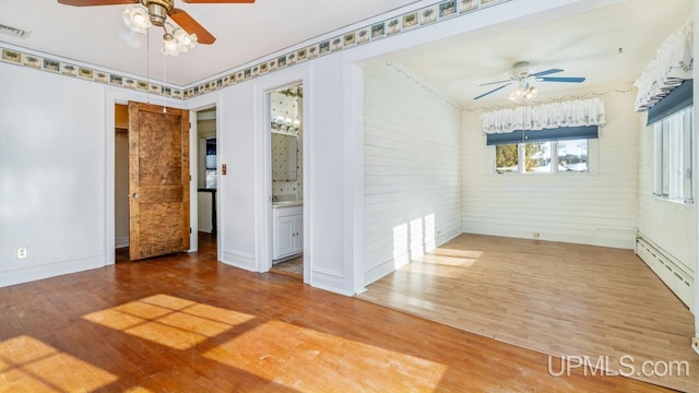 empty room featuring wood-type flooring and ceiling fan