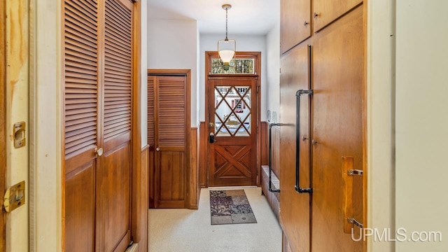 doorway to outside featuring wood walls