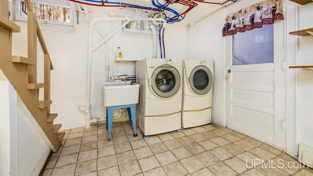 washroom with washer and dryer and sink