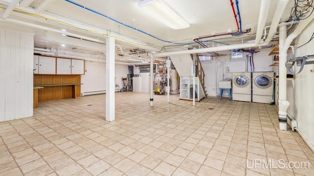 basement featuring separate washer and dryer, sink, and gas water heater