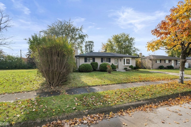 ranch-style home with a front lawn