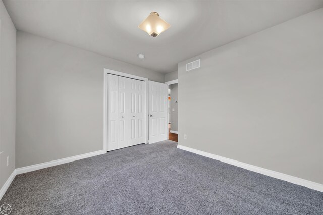 1834 Riley Rd, Saint Clair, MI 48079 - unfurnished bedroom featuring a closet and dark colored carpet