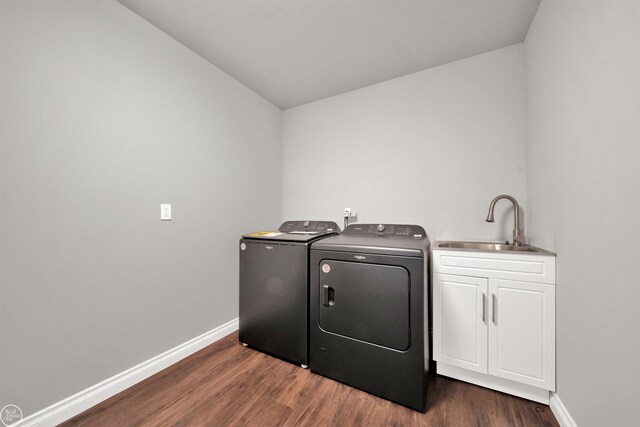 1834 Riley Rd, Saint Clair, MI 48079 - clothes washing area with cabinets, washing machine and dryer, sink, and dark hardwood / wood-style flooring