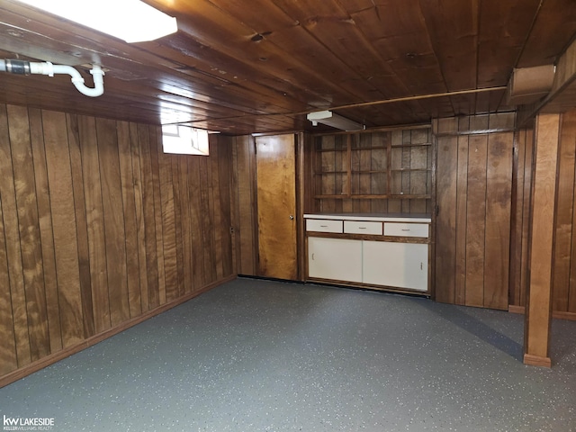 basement featuring wooden ceiling and wood walls