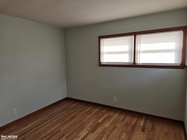 unfurnished room featuring dark wood-type flooring