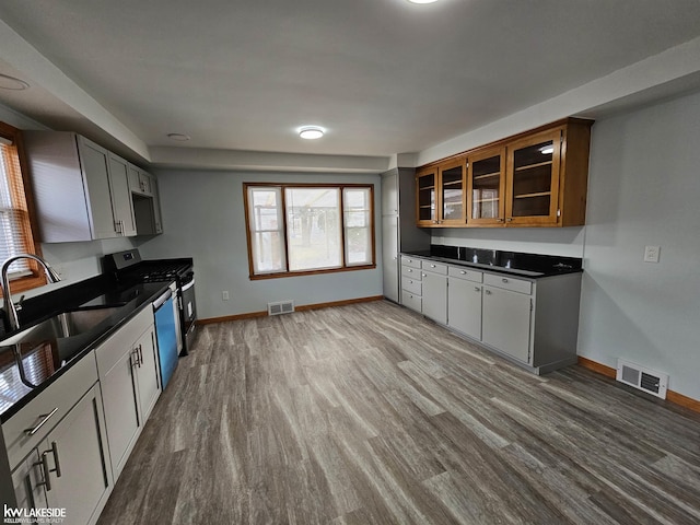 kitchen with white cabinetry, sink, hardwood / wood-style flooring, and stainless steel appliances