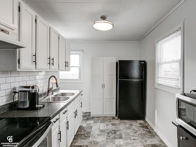 kitchen with white cabinetry, sink, tasteful backsplash, and black fridge