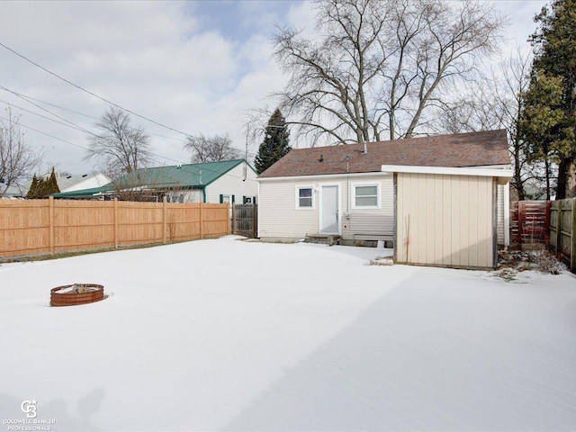 snow covered house with an outdoor fire pit