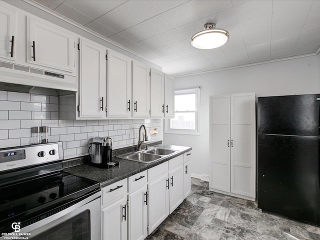 kitchen featuring stainless steel electric range oven, white cabinetry, sink, decorative backsplash, and black fridge