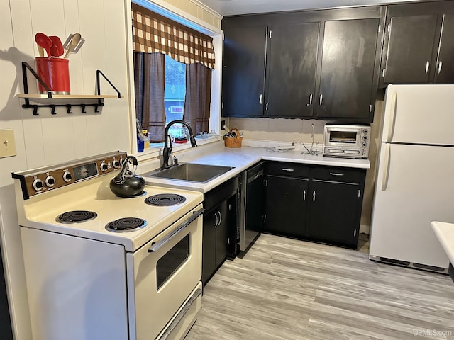 kitchen with sink, white appliances, and light wood-type flooring