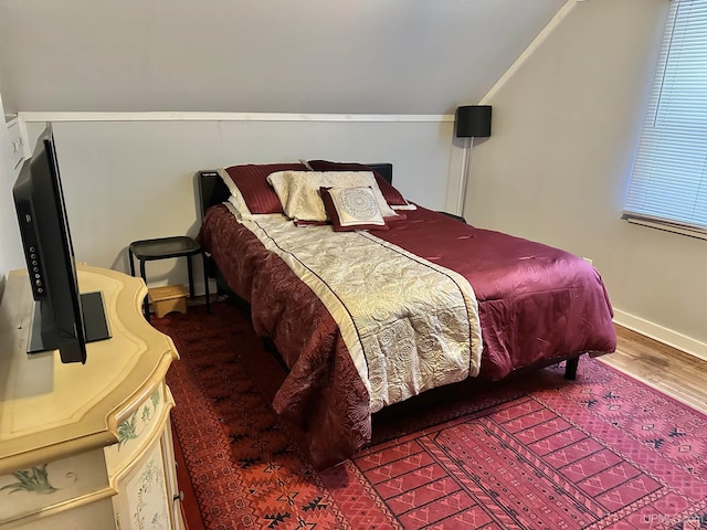 bedroom featuring vaulted ceiling and dark hardwood / wood-style flooring