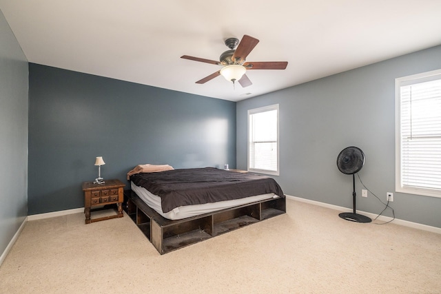 bedroom featuring multiple windows and ceiling fan