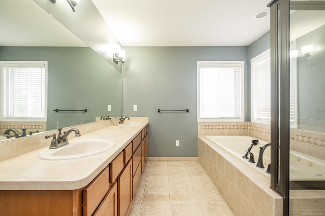 bathroom featuring tile patterned flooring, vanity, and a relaxing tiled tub