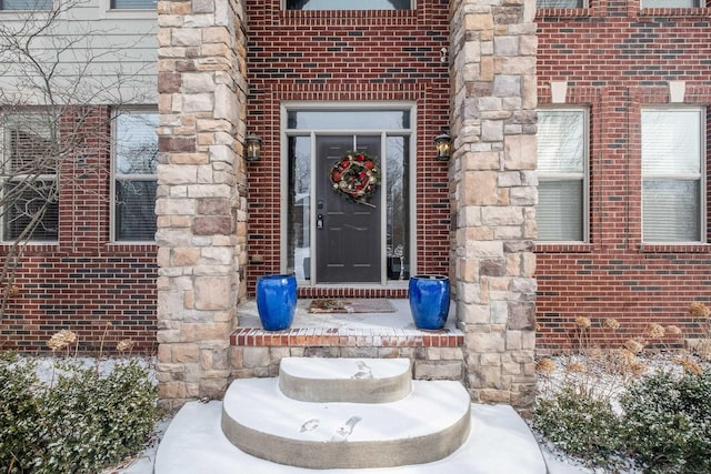 view of snow covered property entrance