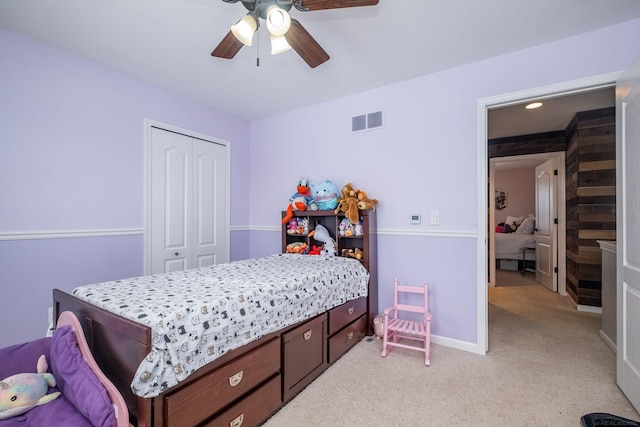 carpeted bedroom featuring a closet and ceiling fan