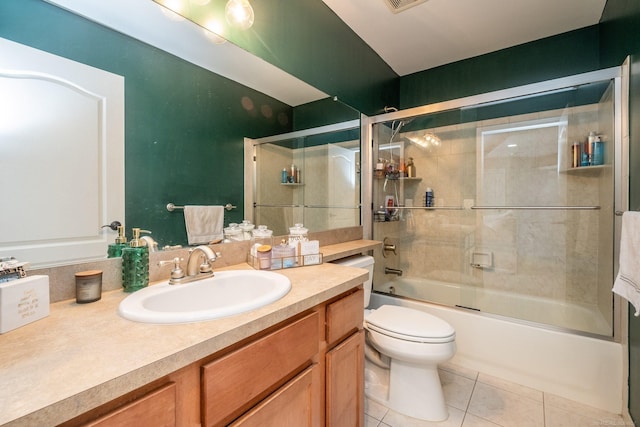 full bathroom with enclosed tub / shower combo, vanity, toilet, and tile patterned flooring