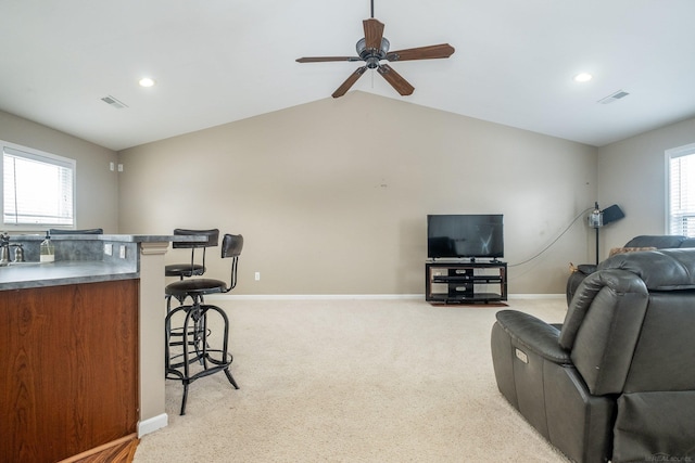 carpeted living room featuring lofted ceiling, a healthy amount of sunlight, and ceiling fan